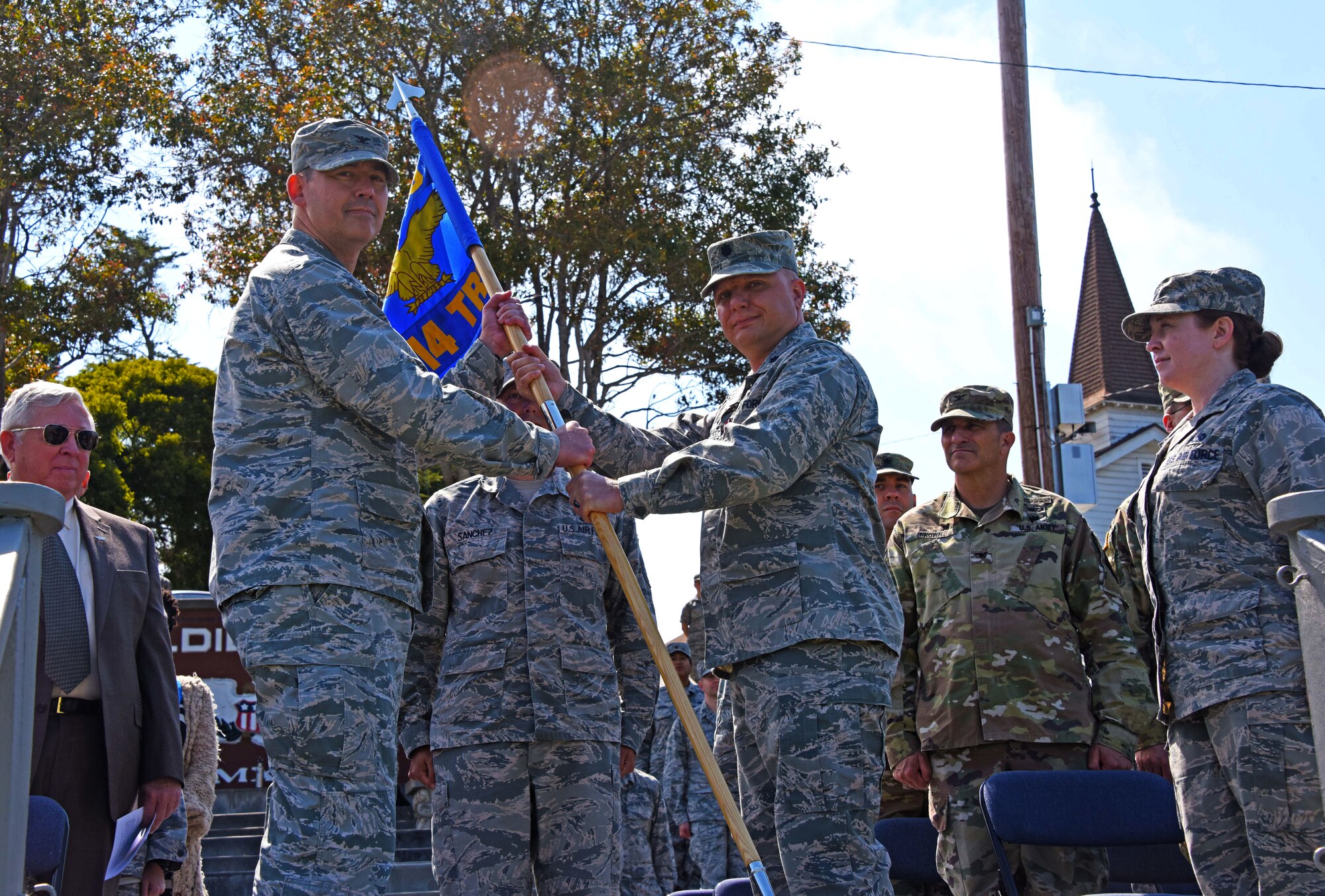 U.S. Air Force Col. Wiley Barnes, 517th Training Group Commander, accepts the 314th Training Squadron guideon from Lt. Col. Christopher Walker, 314th TRS outgoing commander, during the 314th TRS Change of Command at the Presidio of Monterey, California, June 6, 2018. Walker was the 314th TRS commander for two years and helped increase the linguistic ability of hundreds of multi-service personnel in support of national strategic objectives. (U.S. Army photo by Natela Cutter/Released)