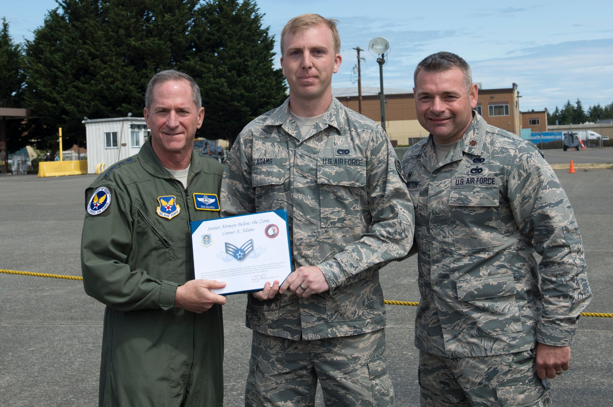Gen David Goldfein, Chief of Staff of the Air Force, presents Airman 1st Class Conner Adams, 62nd Aerial Port Squadron, with a Senior Airman Below the Zone (BTZ) promotion, June 6, 2018, at Joint Base Lewis-McChord, Wash. An Airman selected for a BTZ promotion is promoted to Senior Airman six months earlier than their scheduled time-in-grade promotion. (U.S. Air Force photo by A1C Sara Hoerichs)