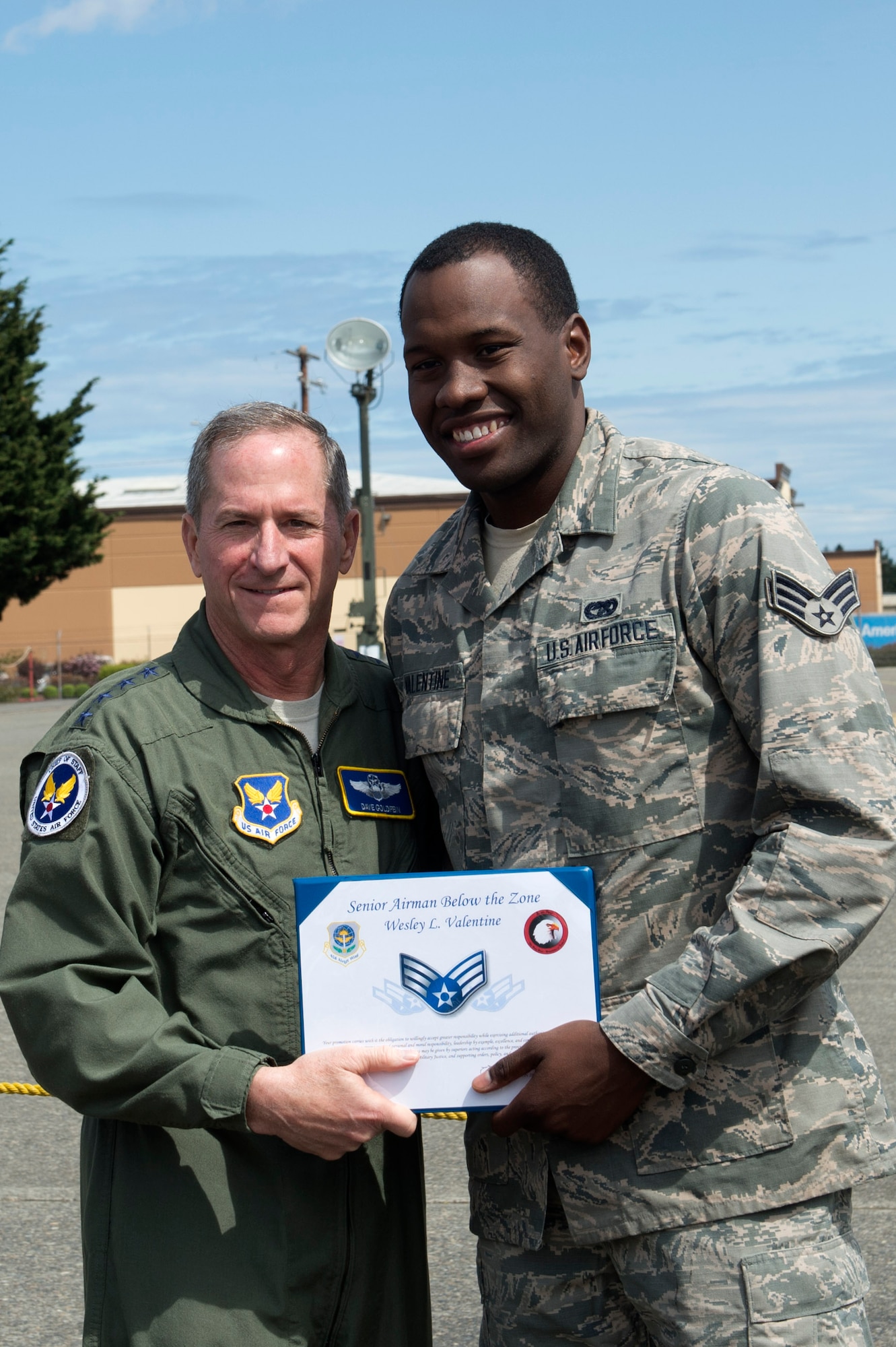Gen David Goldfein, Chief of Staff of the Air Force, presents Airman 1st Class Wesley Valentine, 62nd Aerial Port Squadron, with a Senior Airman Below the Zone (BTZ) promotion, June 5, 2018, at Joint Base Lewis-McChord, Wash. An Airman selected for a BTZ promotion is promoted to Senior Airman six months earlier than their scheduled time-in-grade promotion. (U.S. Air Force photo by A1C Sara Hoerichs)