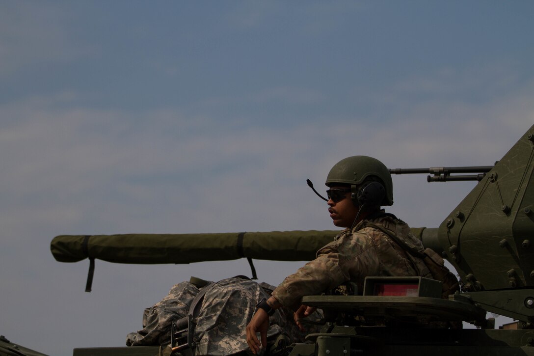 A soldier sits atop of his M1126 Stryker combat vehicle at the distribution point.