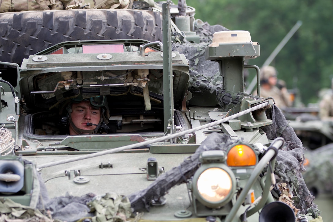 A soldier maneuvers his M1126 Stryker combat vehicle.