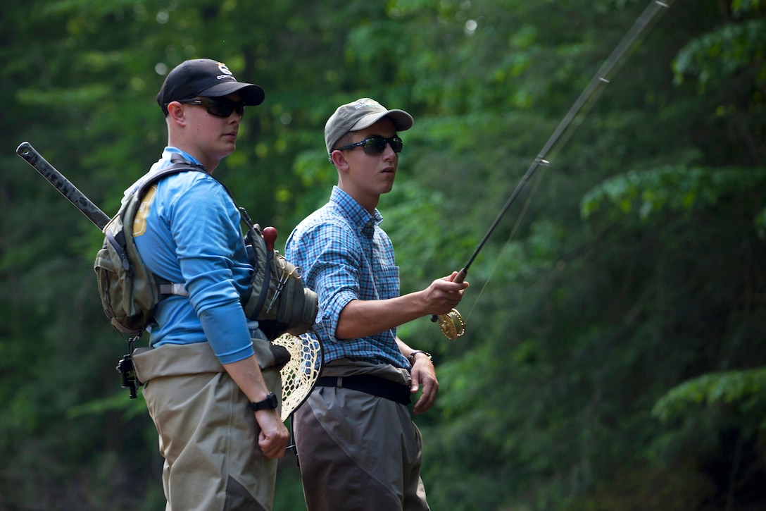 A Marine receives instructions on casting techniques.