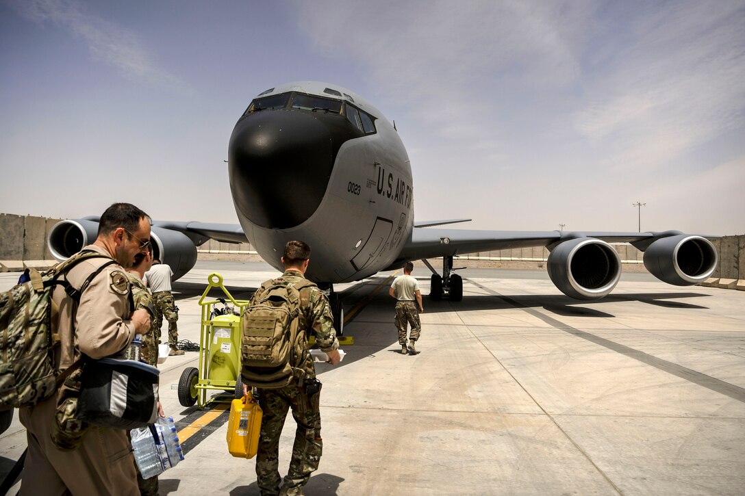 Air Force airmen arrive at the flightline before preparing their KC-135 Stratotanker aircraft.
