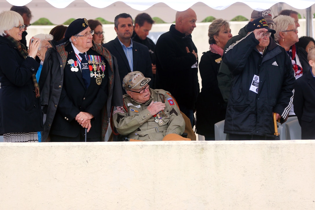 A veteran renders honors during the 74th D-Day commemoration ceremony.