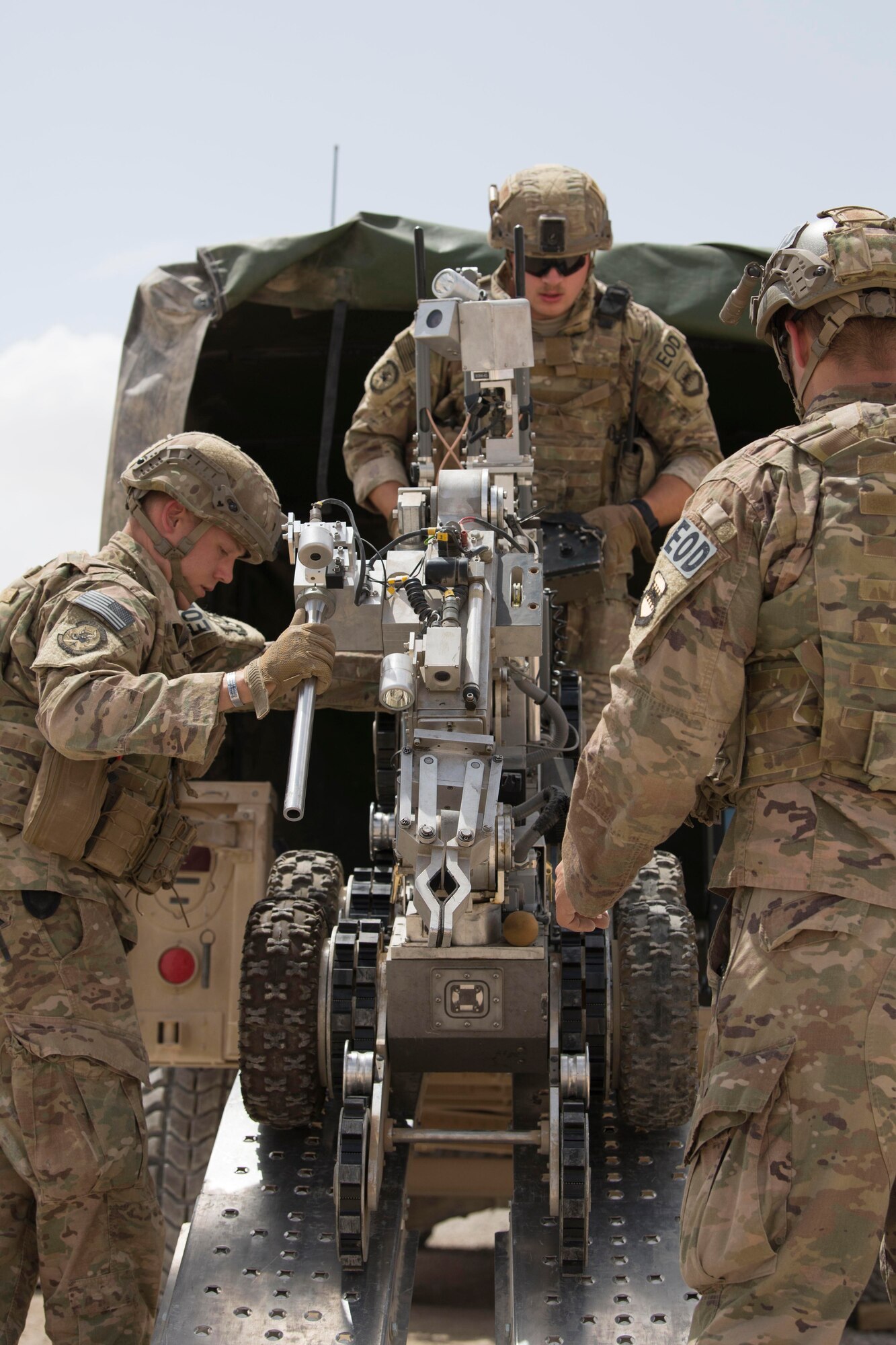 Airmen with the 332nd Expeditionary Civil Engineer Squadron Explosives Ordnance Disposal unit unload a robot used to help identify improvised explosive devices during an exercise at an undisclosed location in Southwest Asia, May 28, 2018.