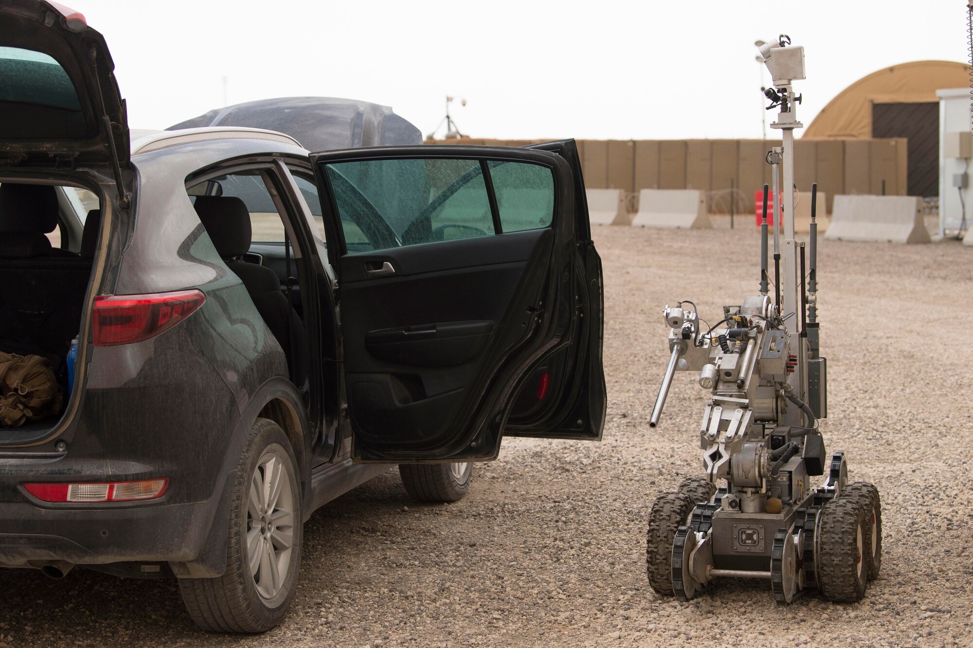 Airmen with the 332nd Expeditionary Civil Engineer Squadron Explosives Ordnance Disposal unit navigate a robot to a vehicle to help locate a possible improvised explosive device during an exercise at an undisclosed location in Southwest Asia, May 28, 2018