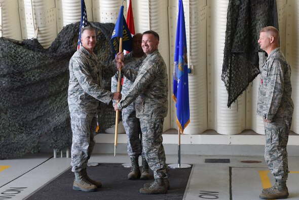 U.S. Air Force Col. David Eaglin, 39th Air Base Wing commander, presents the guidon to Col. Paul Quigley, 39th Weapons System Security Group commander, during the 39th WSSG change of command ceremony at Incirlik Air Base, Turkey, June 7, 2018.