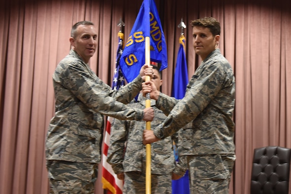 U.S. Air Force Col. Christopher Estridge, 39th Medical Group commander, presents the guidon to Lt. Col. Thomas “Jason” Telfer, 39th Medical Support Squadron commander, during a change of command ceremony at Incirlik Air Base, Turkey, June 8, 2018.