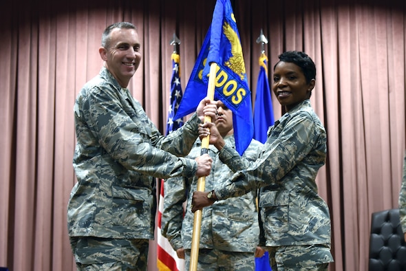 U.S. Air Force Col. Christopher Estridge, 39th Medical Group commander, passes the guidon to Lt. Col. Sarah Evans as she assumes command of the 39th Medical Operations Squadron, during a formal ceremony at Incirlik Air Base, Turkey, June 8, 2018.