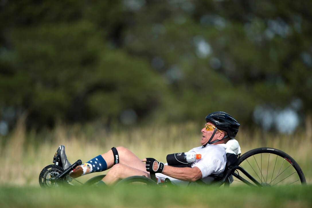 A soldier pedals a recumbent cycle.