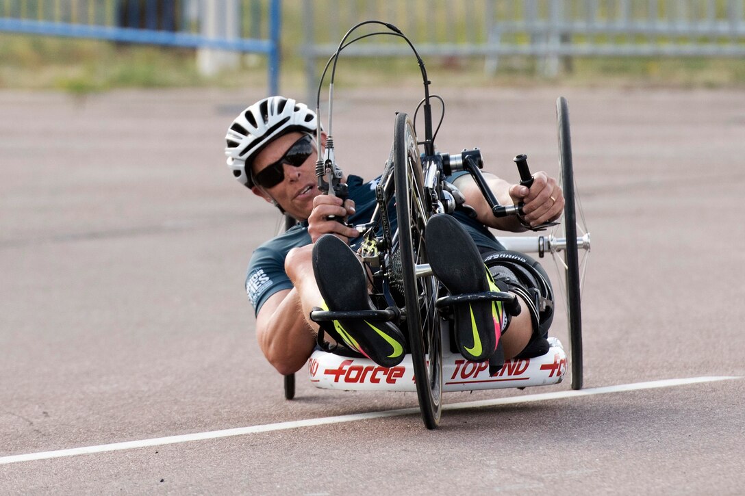 A sailor competes in a cycling event.