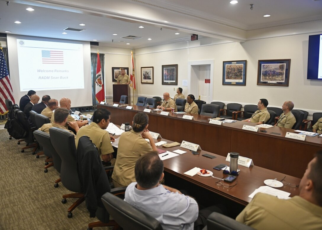 U.S. and Peruvian Naval leaders meet around a table.
