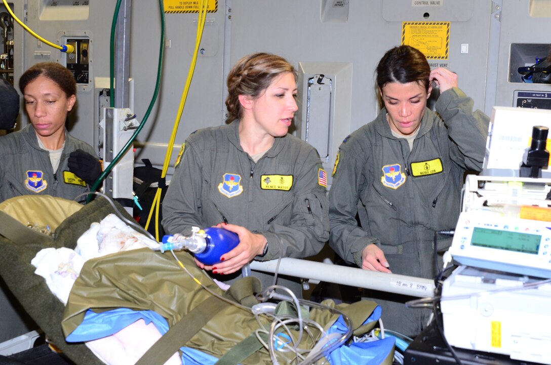 An Air Force medical team helps loading critically injured patients onto an aircraft.