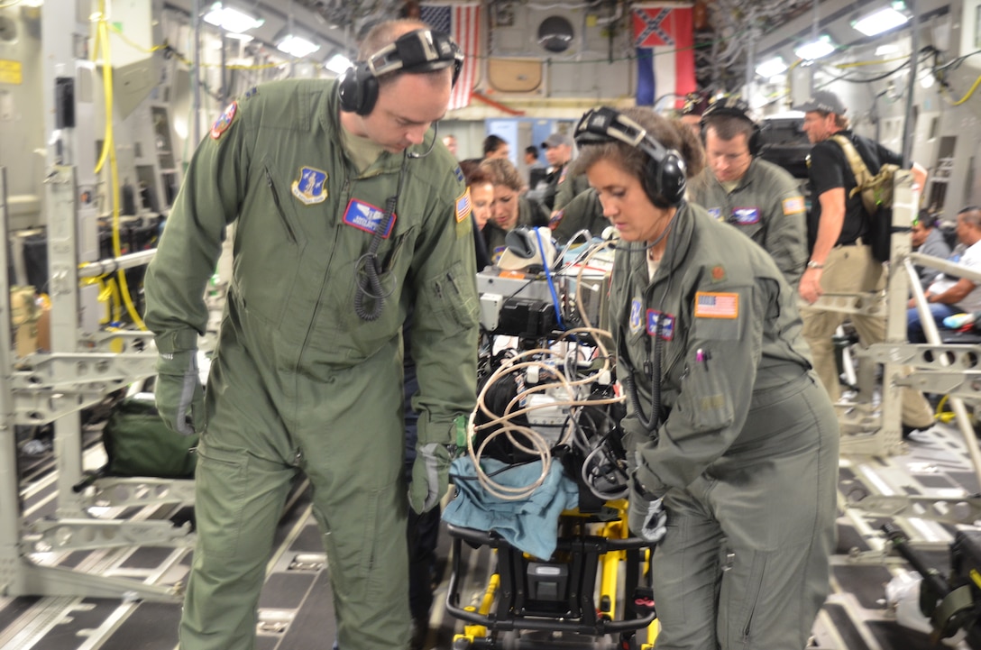 An Air Force medical team helps loading critically injured patients onto an aircraft.