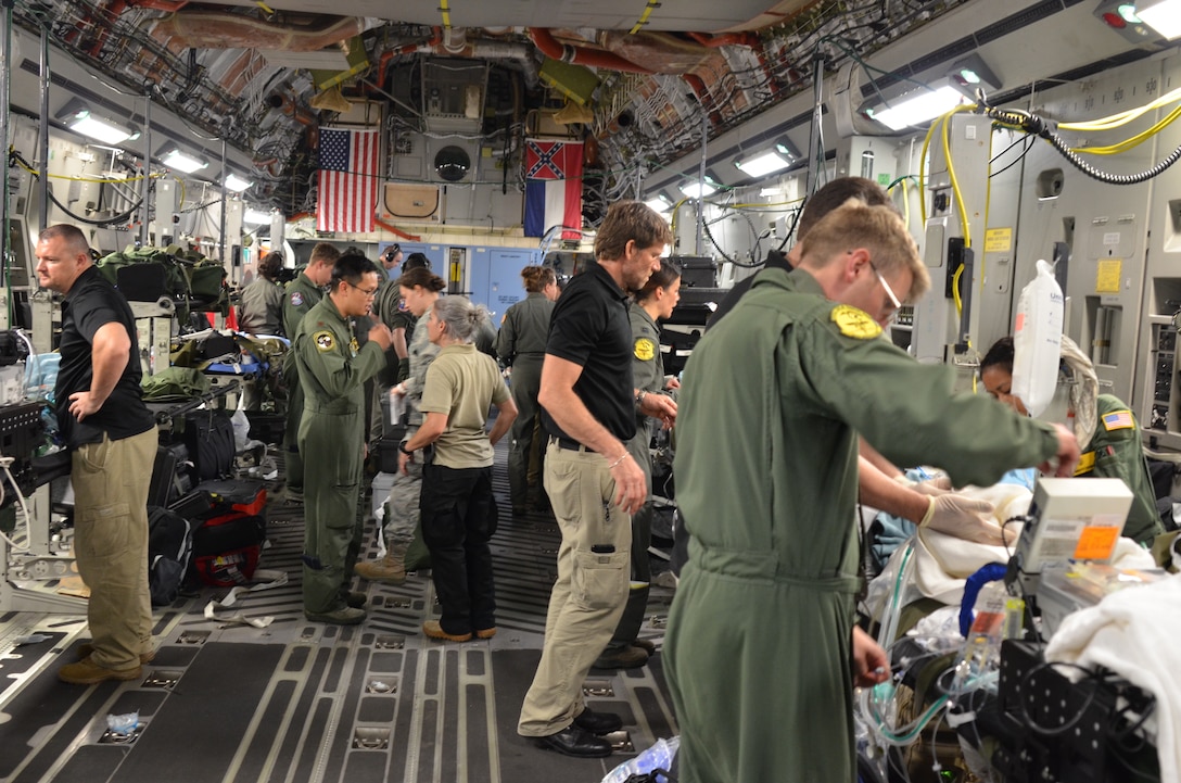 An Air Force medical team helps loading critically injured patients onto an aircraft.
