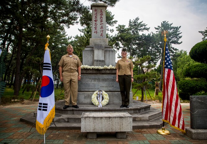 U.S. Navy Capt. Denis Cox (left) and U.S. Marine Col. Maria McMillen (right) in front of the 1st Marine Aircraft Memorial Monument during a memorial ceremony at Pohang City Battle Monument and 1st MAW Memorial Monument in Pohang, South Korea, June 6, 2018. The Korea Freedom Federation Songdo Branch hosted the ceremony to remember the fallen service members who gave the ultimate sacrifice in the Korean War. Cox, a native of Columbus, Ohio, is 1st MAW’s wing chaplain. McMillen, a Craig, Colorado native, is the G-5 assistance chief of staff with 1st MAW.