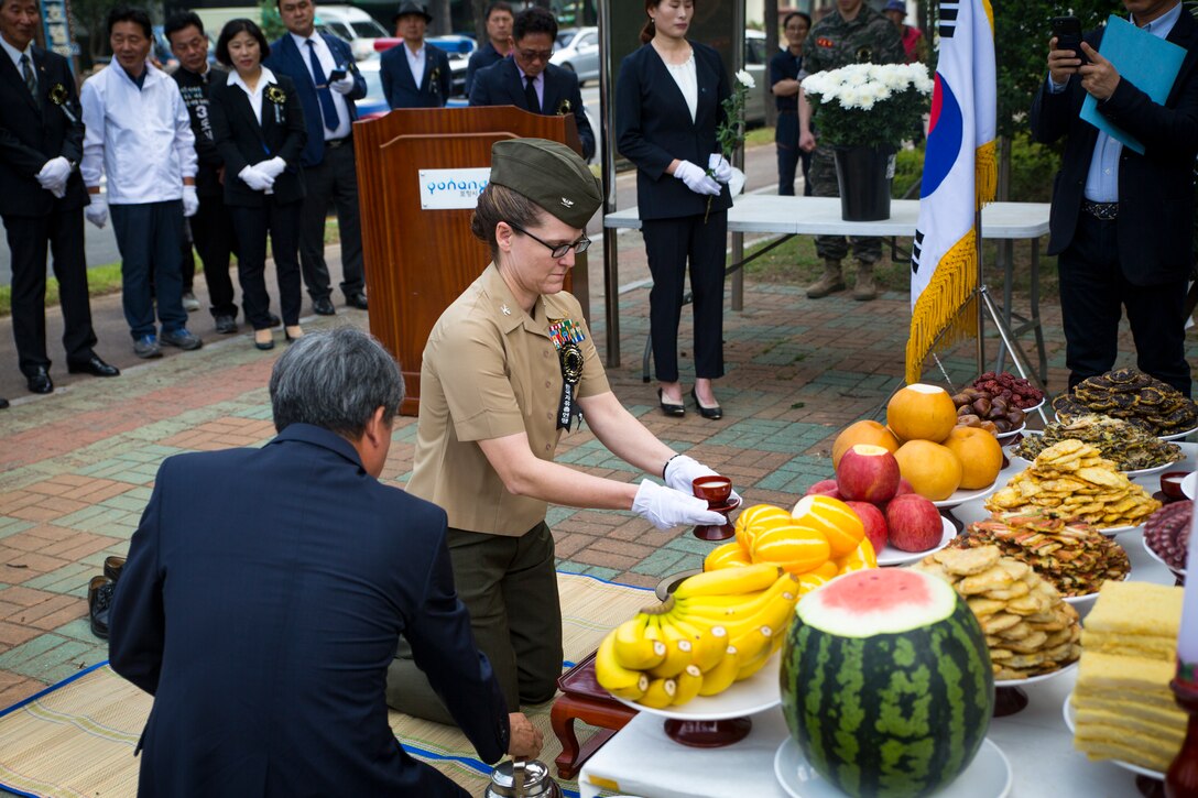 U.S. Marine Col. Maria McMillen participates in the Korean ancestral memorial rites ritual during a memorial ceremony at Pohang City Battle Monument and 1st Marine Aircraft Wing Memorial Monument in Pohang, South Korea, June 6, 2018. The Korea Freedom Federation Songdo Branch hosted the ceremony to remember the fallen service members who gave the ultimate sacrifice in the Korean War. McMillen, a Craig, Colorado native, is the G-5 assistance chief of staff with 1st MAW.