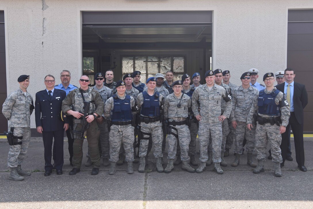 Service members assigned to the 569th U.S. Forces Police Squadron pose with Polizei on Kapaun Air Station, Germany, June 6, 2018. This joint unit services over 4,000 calls a year, focusing on the 1,100 square mile county of Kaiserslautern.