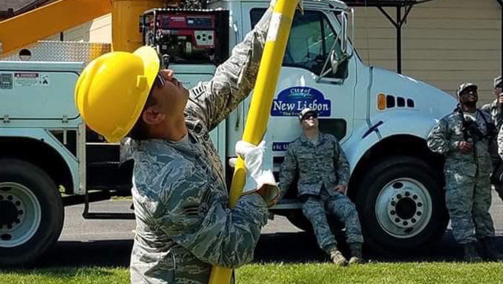 Senior Airman Mohammed Alzubaidi, an electrical systems specialist with the 118th Civil Engineer Squadron, works on power line fuses on July 17, 2017 at Volk Field Air National Guard Base, Camp Douglas, Wisconsin .