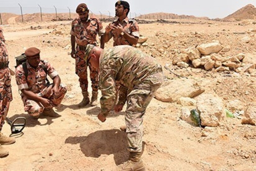 Maj. Brian Sayer, 35th Engineer Brigade, Task Force Spartan, shares with Omani Soldiers methods to determine the size of a possible improvised explosive devices (IEDs) they located during a multi-day training event. The training also gave the Omani soldiers an opportunity to demonstrate the use of equipment they use to counter the threat posed by IED.