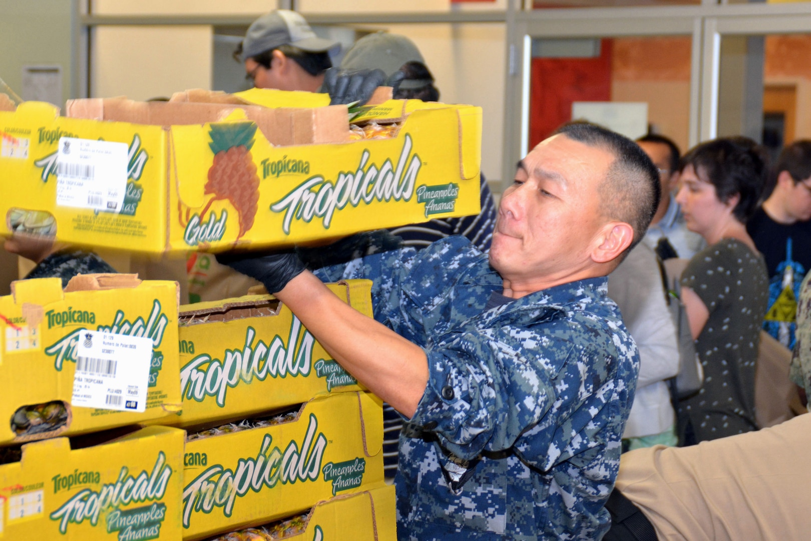 Petty Officer 1st Class Thao Tran, a recruiter assigned to Navy Recruiting Station De Zavala, Navy Recruiting District San Antonio, volunteers at the San Antonio Food Bank during a Delayed Entry Program meeting June 6. Tran, originally from Vietnam, has served in the Navy for more than 16 years and became a recruiter in 2017.  During the event, recruiters, along with more than 60 future Sailors and other volunteers, filled 575 bags of produce and sorted 19,447 pounds of food which will provide 15,558 meals for needy families.  The purpose of the volunteerism was to instill the “Whole Sailor Concept.”