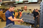 Petty Officer 1st Class Milton Duarte (right), a recruiter assigned to Navy Recruiting Station De Zavala, Navy Recruiting District San Antonio, and Diego Rodriguez, a future Sailor from Del Rio, Texas, volunteers at the San Antonio Food Bank during a Delay Entry Program meeting June 6.  Duarte, a 2003 graduate of South Bronx High School, joined the Navy in 2005.  Rodriguez, a 2014 graduate of Del Rio High School, will serve as an electrician’s mate in America’s Navy.