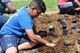 With the help of the 88th Civil Engineering Group’s Natural Resources division, Junior Sanabia, 9, builds a monarch waystation by planting native plants to attract monarch butterflies.  Monarch waystations are natural habitats created with specific plant species that monarch butterflies need to survive.  (U.S. Air Force photo/Stacey Geiger)