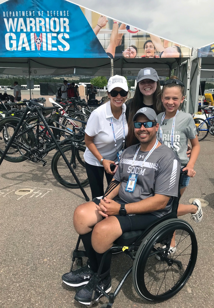 U.S. Special Operations Command's Army Master Sgt. George Vera; his wife, Angela; and daughters, Sydney, 19, and Isabella, 11, stop for a family photo between the cycling time trial and road race competitions during the 2018 Department of Defense Warrior Games in Colorado Springs, Colo.