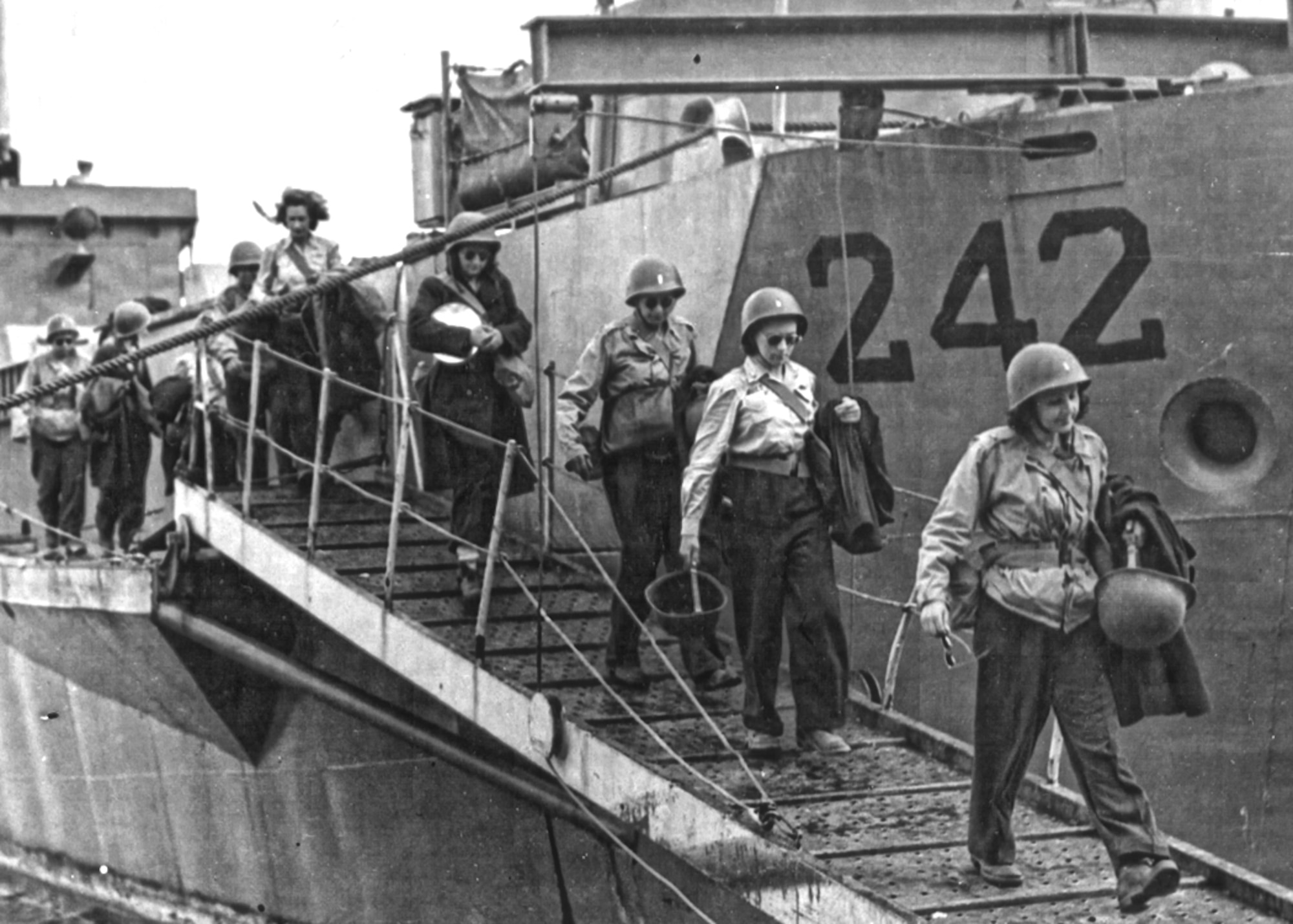 U.S. Army Air Forces nurses make their way down the ramp of their Landing Craft Infantry amphibious assault ship on the Mediterranean island of Pantelleria, Italy in 1943. The 34th Station Hospital on the island became the first Army Air Forces hospital truly attached to an Army Air Forces unit. (National Archives)