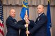 Brig. Gen. Carl Schaefer, 412th Test Wing commander (left), hands Col. Jeffry Hollman, the 412th Mission Support Group guidon during an assumption of command ceremony held June 4 at Club Muroc. (U.S. Air Force photo by Christopher Okula)