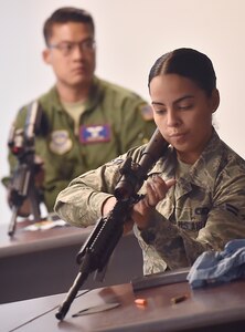 Airman 1st Class Jeanette Medina Vega, 437th Aerial Port Squadron passenger travel technician, learns the fundamentals of an M-4 rifle from Senior Airman Dylan Ricketts, 628th Security Forces Squadron Combat Arms Training and Maintenance instructor, during a classroom session June 5, 2018, at Joint Base Charleston, S.C. CATM instructors at Joint Base Charleston support all military branches and are responsible for qualifying service members and civilians on various weapons