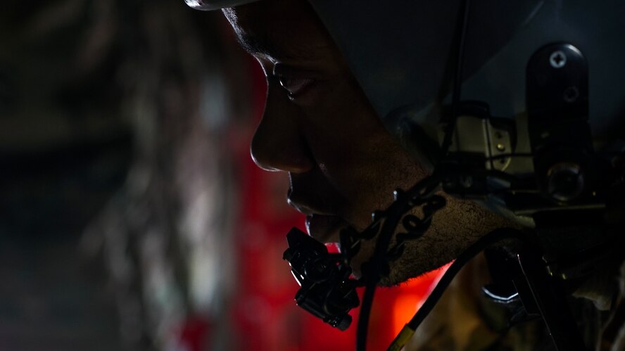 A C-130H Hercules loadmaster assigned to the 746th Expeditionary Airlift Squadron, Al Udeid Air Base, Qatar, listens to pilot instructions prior to a combat airdrop over an undisclosed location June 3, 2018. This was the first combat air drop for the loadmaster who is deployed from the 908th Airlift Wing, Maxwell Air Force Base, Ala. (U.S. Air Force photo by Master Sgt. Burt Traynor)