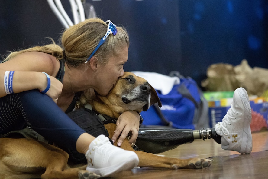 Retired Senior Airman Heather Carter takes a break with service dog Rocky after competing in sitting volleyball at the Department of Defense Warrior Games 2018.  Warrior Games is a Paralympic style competition where wounded warriors compete in 11 different adaptive sporting events. Competition this year started June 1 and runs through June 9.  (U.S. Air Force photo by Master Sergeant David Long)
