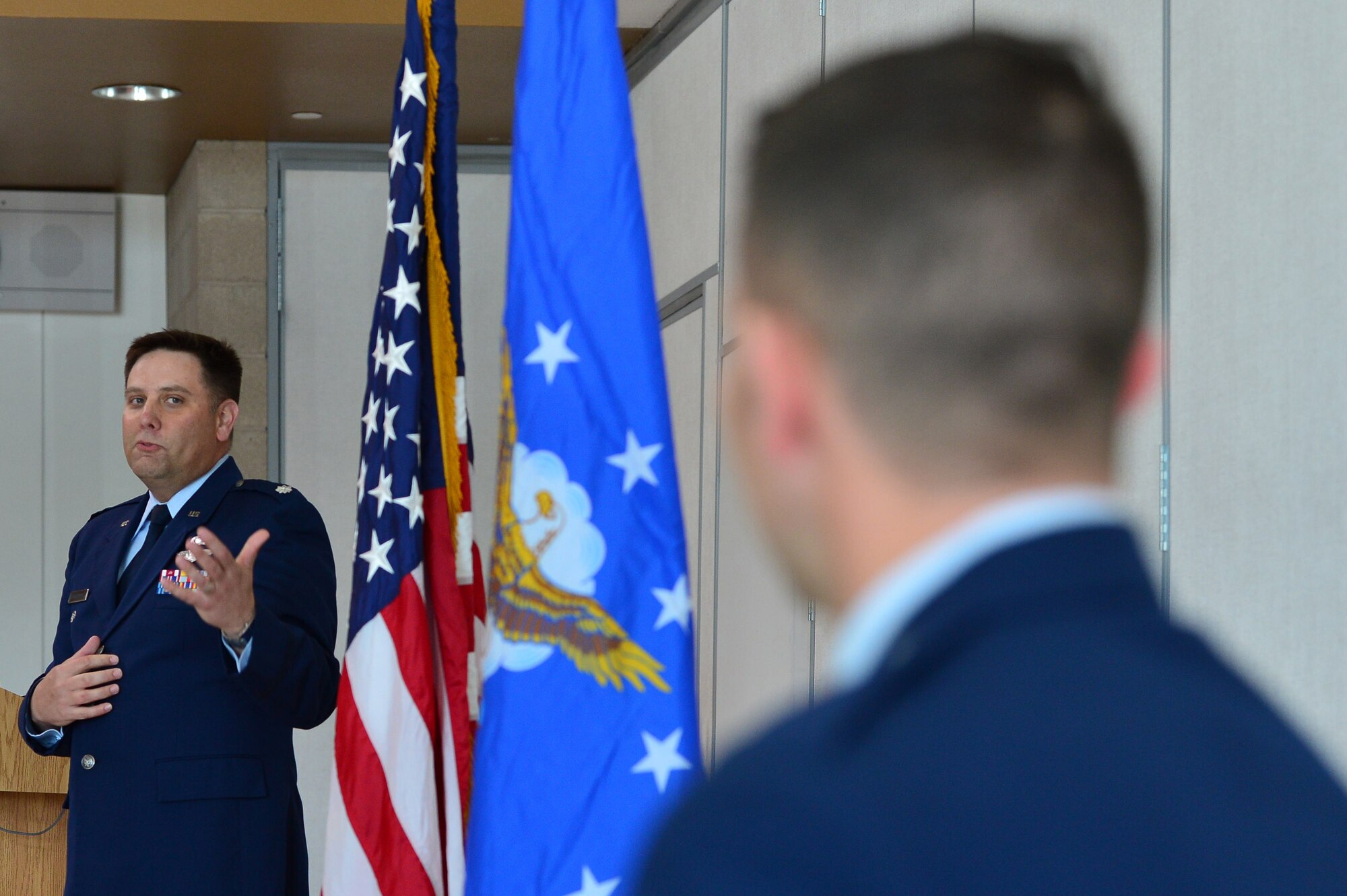 Lt. Col. Daniel Finkelstein, presiding officer of Maj. Phillip’s promotion, talks about the accomplishments of Maj. Phillip, 732nd Operations Group chief of intelligence, during his promotion ceremony March 31, 2018, in Las Vegas. Phillip received a Reserve Officers’ Training Corps scholarship and commissioned upon graduation in 2008. (U.S. Air Force photo by Airman 1st Class Haley Stevens)