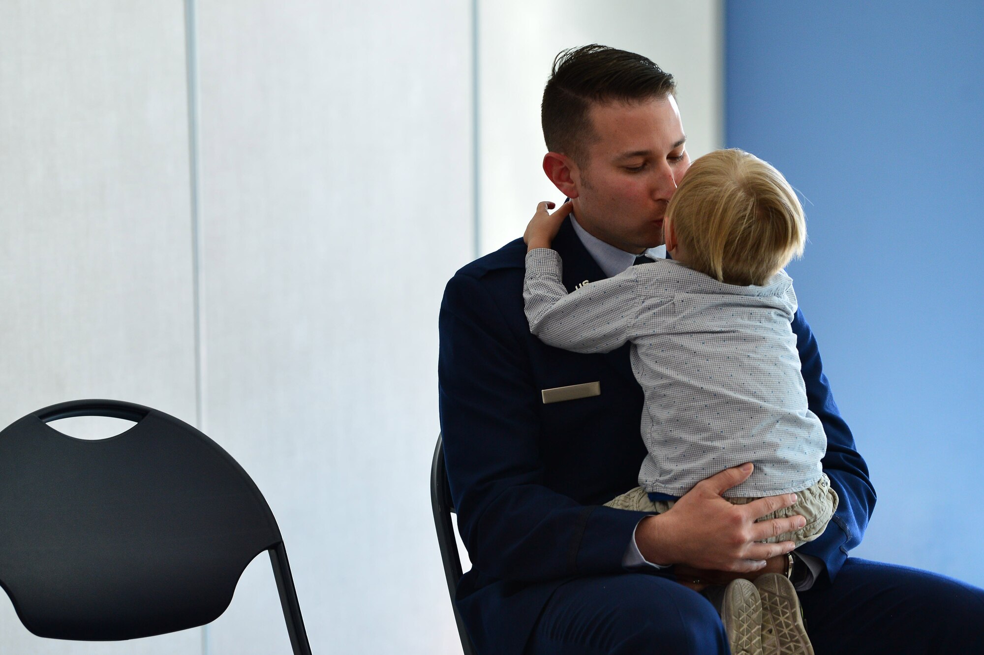 Maj. Phillip, 732nd Operations Group chief of intelligence, gives his son a kiss during his promotion ceremony March 31, 2018, in Las Vegas. Many of Phillip’s family members travelled from all over the nation to celebrate his promotion. (U.S. Air Force photo by Airman 1st Class Haley Stevens)