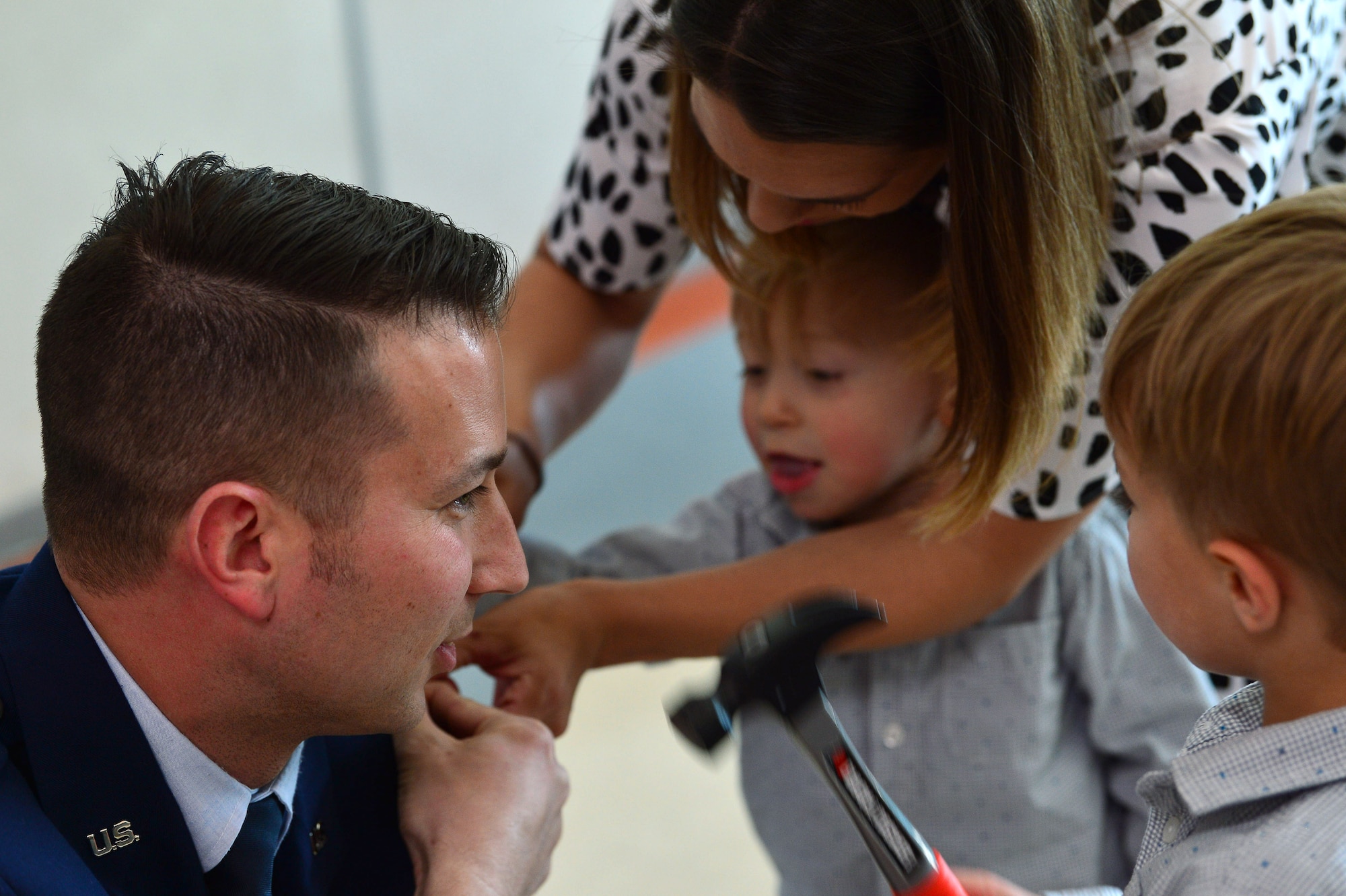 Maj. Phillip, 732nd Operations Group chief of intelligence, gets his rank pinned on by his wife and children during his promotion ceremony March 31, 2018, in Las Vegas. Phillip was surrounded by family and friends who came to celebrate his promotion to major. (U.S. Air Force photo by Airman 1st Class Haley Stevens)