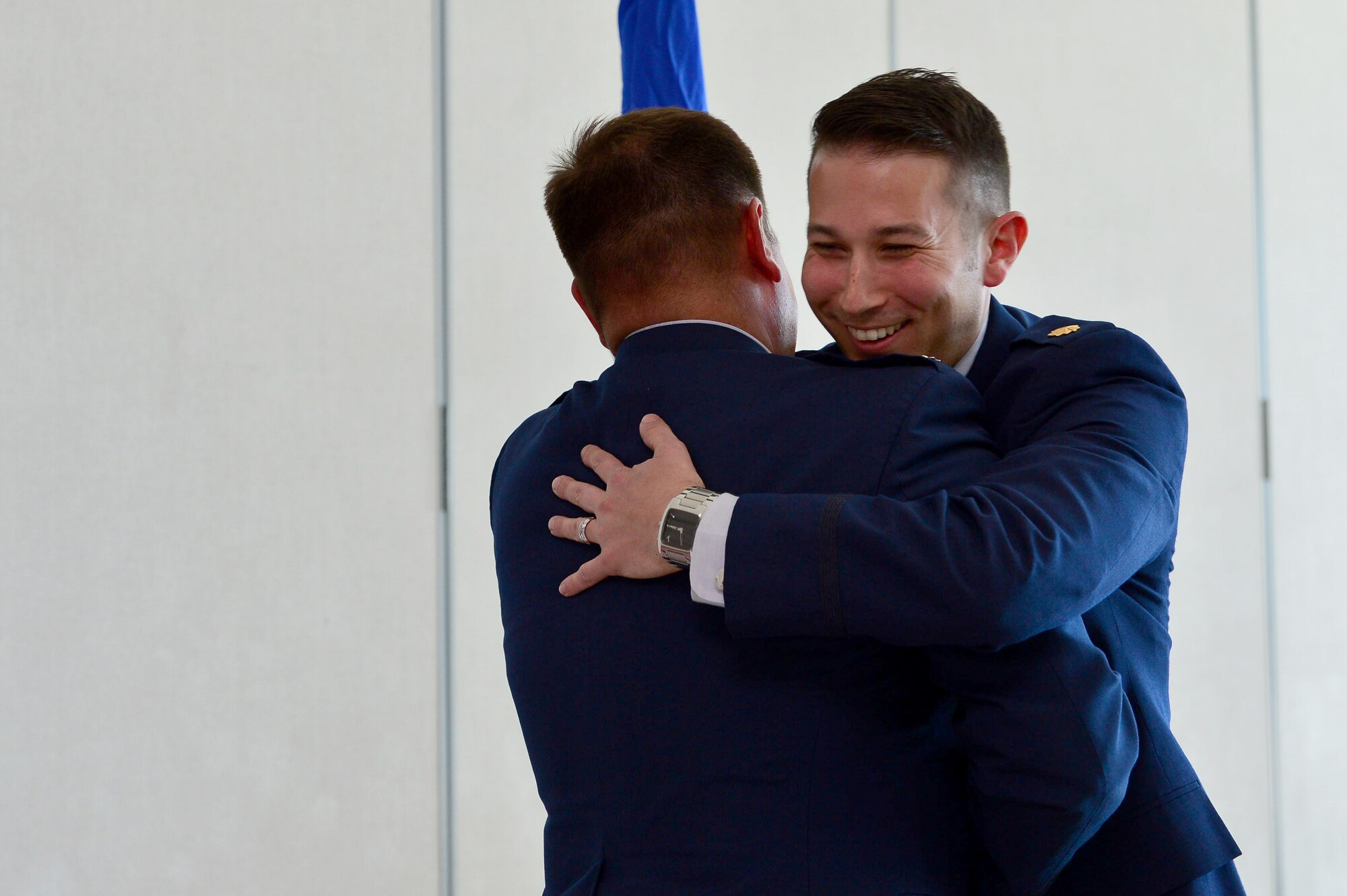 Maj. Phillip, 732nd Operations Group chief of intelligence, hugs Lt. Col. Daniel Finkelstein, presiding officer of Maj. Phillip’s promotion, after his oath of office March 31, 2018, in Las Vegas. Phillip has served in the U.S. Air Force for 10 years and is proud to continue his family’s legacy as a third generation Airman. (U.S. Air Force photo by Airman 1st Class Haley Stevens)
