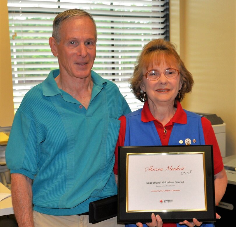 Sharon Monheit, right, an American Red Cross volunteer serving at the Naval Health Clinic Charleston Pharmacy, was awarded the Exceptional Volunteer Award for Service to the Armed Forces from the American Red Cross Palmetto, South Carolina Region June 5, 2018, at NHCC, located on Joint Base Charleston – Naval Weapons Station.