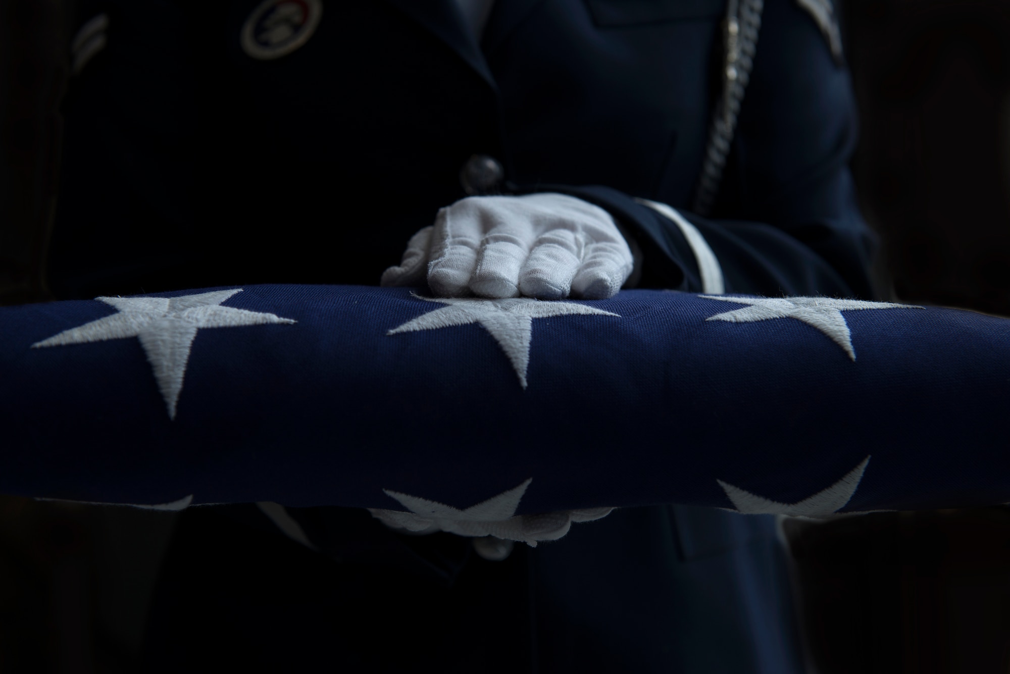 Presentation of a folded American flag to a family member is a key part of the military honors rendered during a veteran's funeral. (N.H. Air National Guard photo by Staff Sgt. Kayla White)