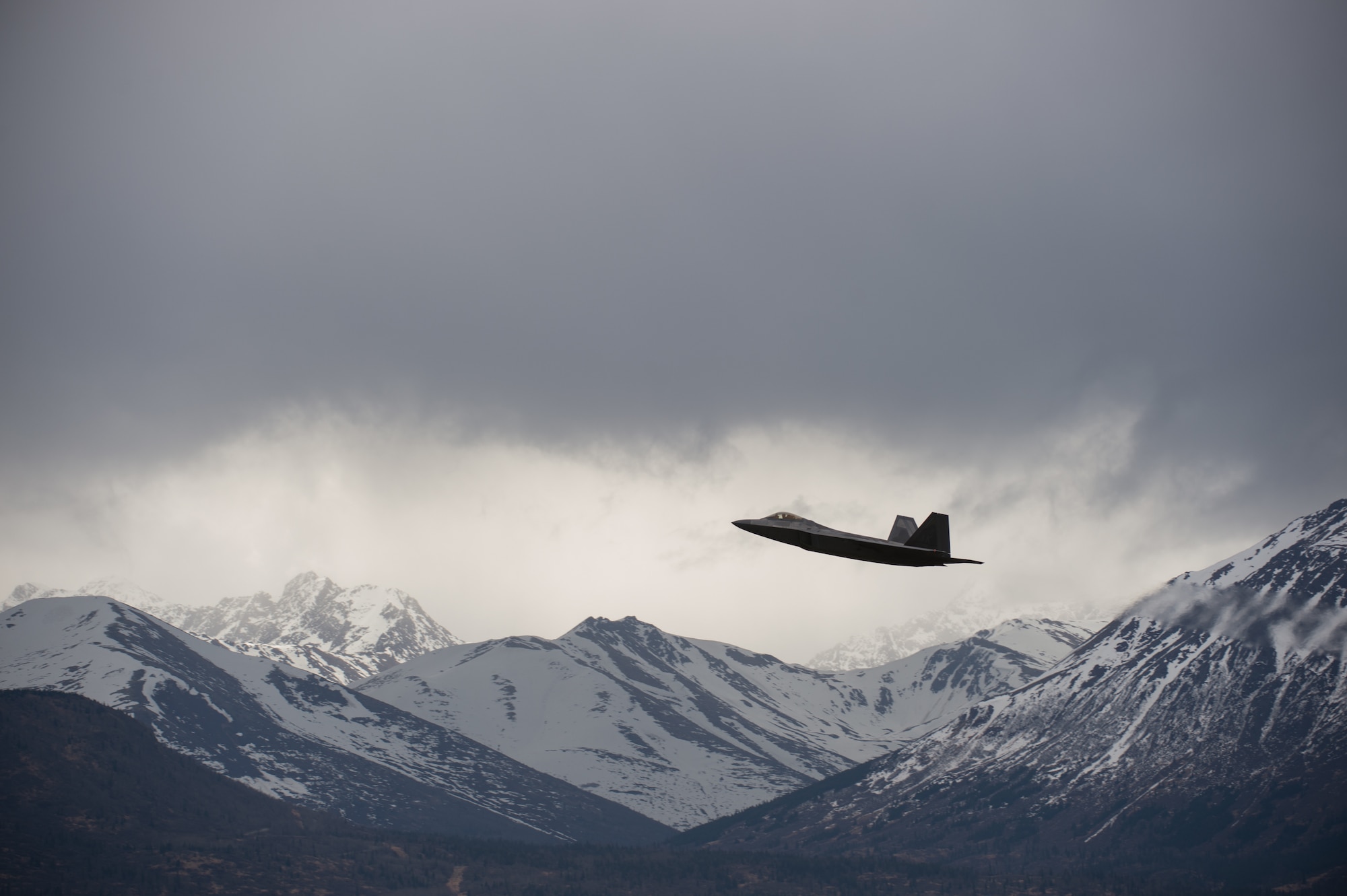 An F-22 Raptor soars over the Chugach Mountains near Joint Base Elmendorf-Richardson, Alaska, May 10, 2018. The F-22’s combination of stealth, supercruise, maneuverability, and integrated avionics, coupled with improved supportability, represents an exponential leap in warfighting capabilities. The Raptor performs both air-to-air and air-to-ground missions allowing full realization of operational concepts vital to the 21st century Air Force.