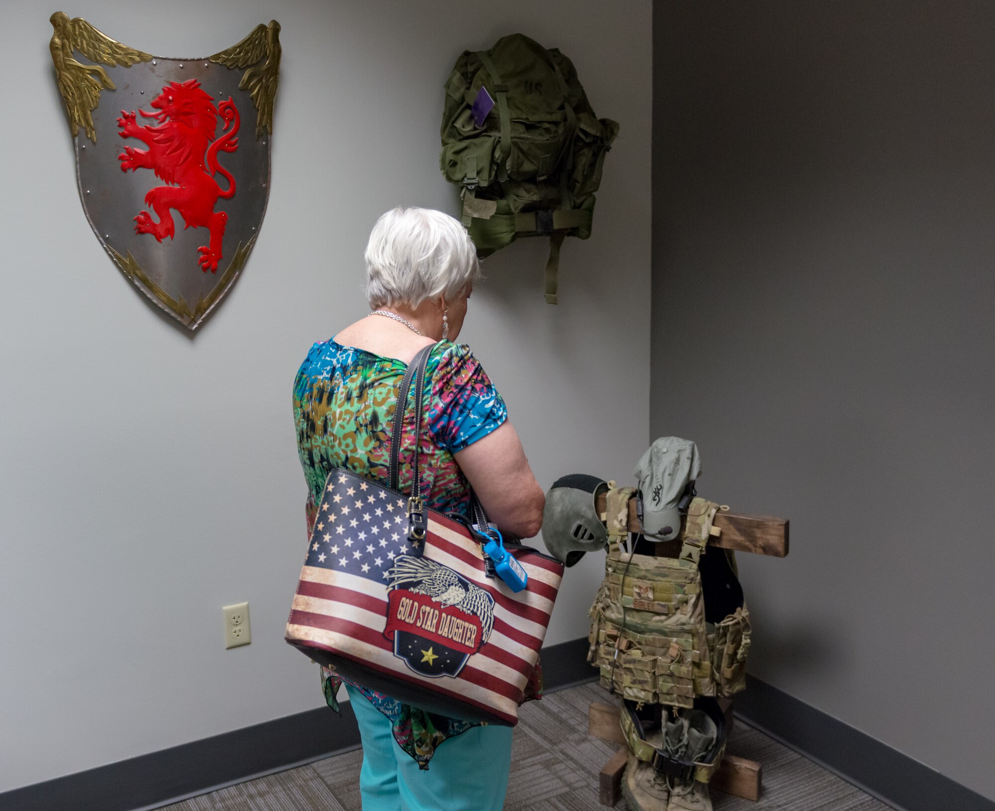 Diane Moore, Gold Star Family Member, admires a fallen Airman memorial at Cody Hall during the 81st Training Group Honorary Commanders' tour on Keesler Air Force Base, Mississippi, June 7, 2018. The event also included tours at the 338th Training Squadron and the 81st Training Support Squadron Trainer Development Center. (U.S. Air Force photo by Andre Askew)