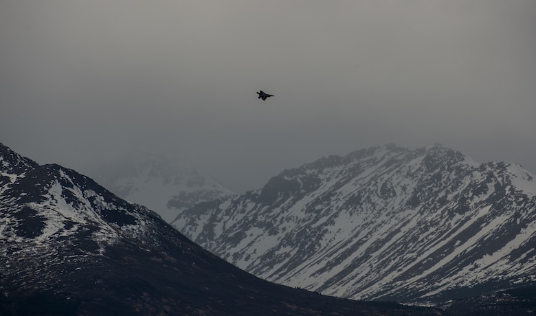 An F-22 Raptor soars over the Chugach Mountains near Joint Base Elmendorf-Richardson, Alaska, May 10, 2018. The F-22’s combination of stealth, supercruise, maneuverability, and integrated avionics, coupled with improved supportability, represents an exponential leap in warfighting capabilities. The Raptor performs both air-to-air and air-to-ground missions allowing full realization of operational concepts vital to the 21st century Air Force.