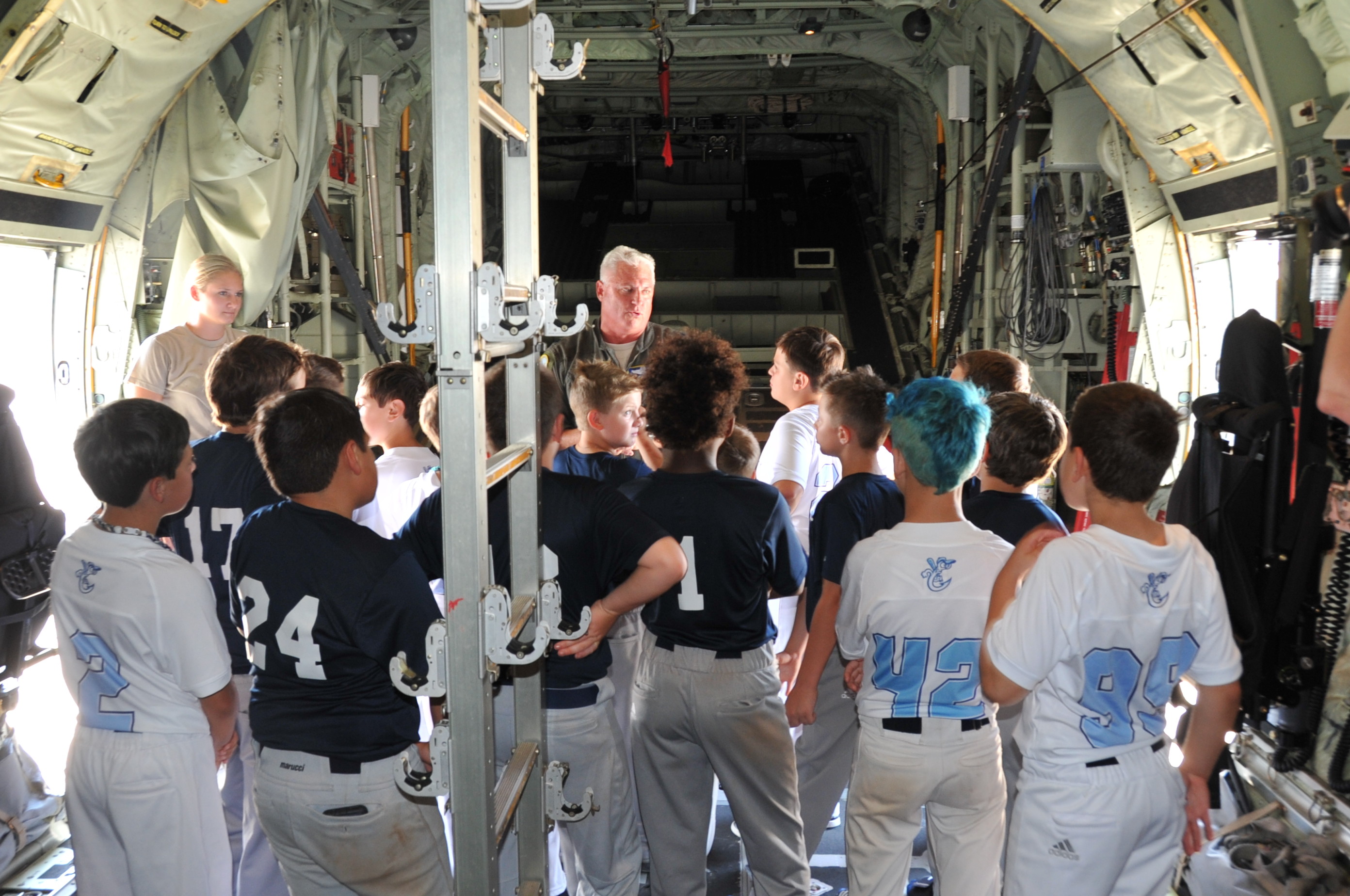 Lt. Col. Shane Devlin, 53rd Weather Reconnaissance pilot instructor, gives the Crescent City Hooks youth baseball team a tour of a WC-130J at Keesler Air Force Base, Miss. today. (U.S. Air Force photo by Master Sgt. Jessica Kendziorek)