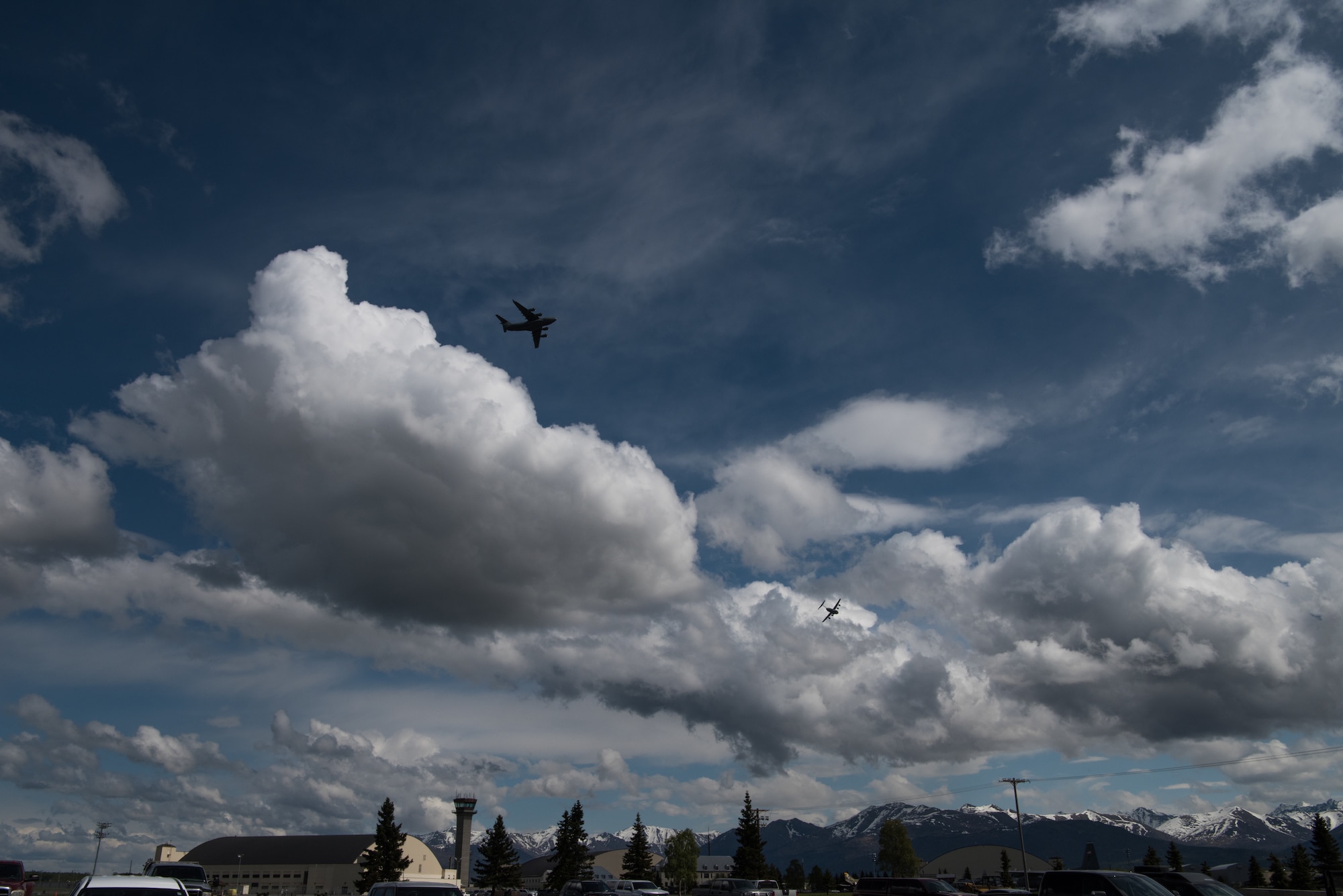 Two Alaska Air National Guard C-17 Globemaster III aircraft assigned to the 176th Wing fly over Joint Base Elmendorf-Richardson, Alaska, May 24, 2018. The C-17 Globemaster III is the newest, most flexible cargo aircraft to enter the airlift force. It’s capable of rapid strategic delivery of troops and all types of cargo to main operating bases or directly to forward bases in the deployment area.