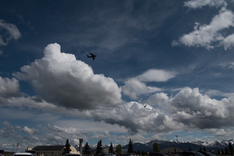 Two Alaska Air National Guard C-17 Globemaster III aircraft assigned to the 176th Wing fly over Joint Base Elmendorf-Richardson, Alaska, May 24, 2018. The C-17 Globemaster III is the newest, most flexible cargo aircraft to enter the airlift force. It’s capable of rapid strategic delivery of troops and all types of cargo to main operating bases or directly to forward bases in the deployment area.