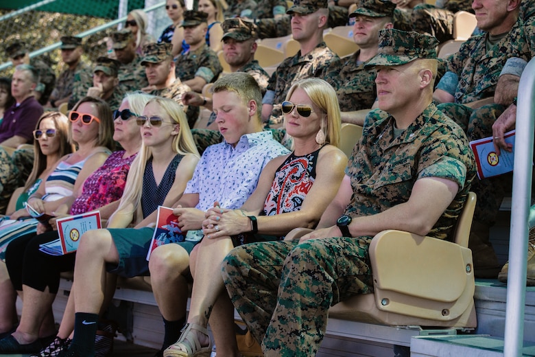 Lt. Col. Erick T. Clark, off-going commanding officer, 1st Battalion, 7th Marine Regiment, sits with his family during the unit’s change of command ceremony aboard the Marine Corps Air Ground Combat Center, Twentynine Palms, Calif., June 4, 2018. The change of command ceremony ensures that the unit and its Marines are never without official leadership, and also signifies an allegiance of Marines to their unit’s commander. (U.S. Marine Corps photo by Lance Cpl. Rachel K. Porter)