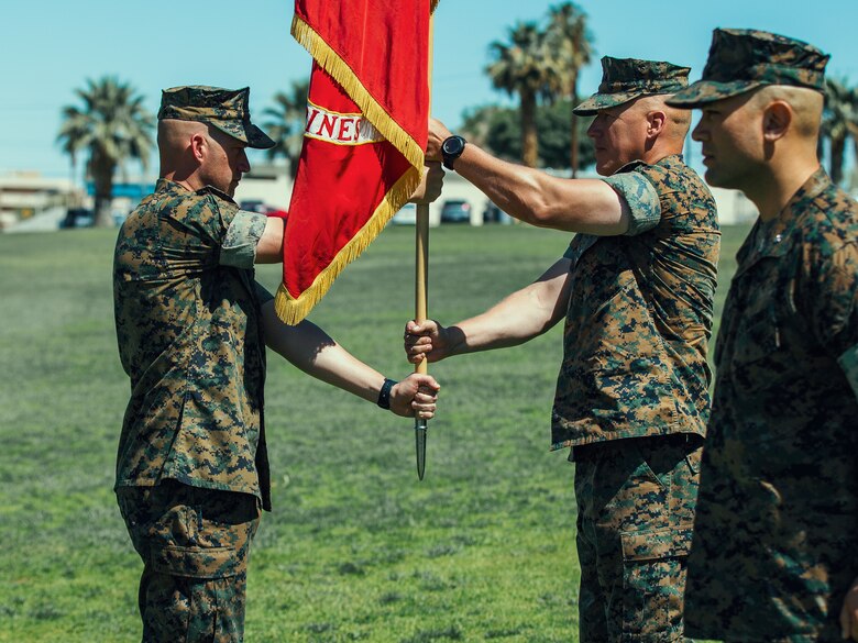 Sgt. Maj. Brian E. Anderson, sergeant major, 1st Battalion, 7th Marine Regiment, passes the battalion colors to Lt. Col. Erick T. Clark, off-going commanding officer, 1st Battalion, 7th Marine Regiment, during the unit’s change of command ceremony aboard the Marine Corps Air Ground Combat Center, Twentynine Palms, Calif., June 4, 2018. The exchange of colors, from an outgoing commander to an incoming one, is the crowning moment of the ceremony and ensures that the unit and its Marines are never without official leadership and also promotes a continuation of trust. (U.S. Marine Corps photo by Lance Cpl. Rachel K. Porter)