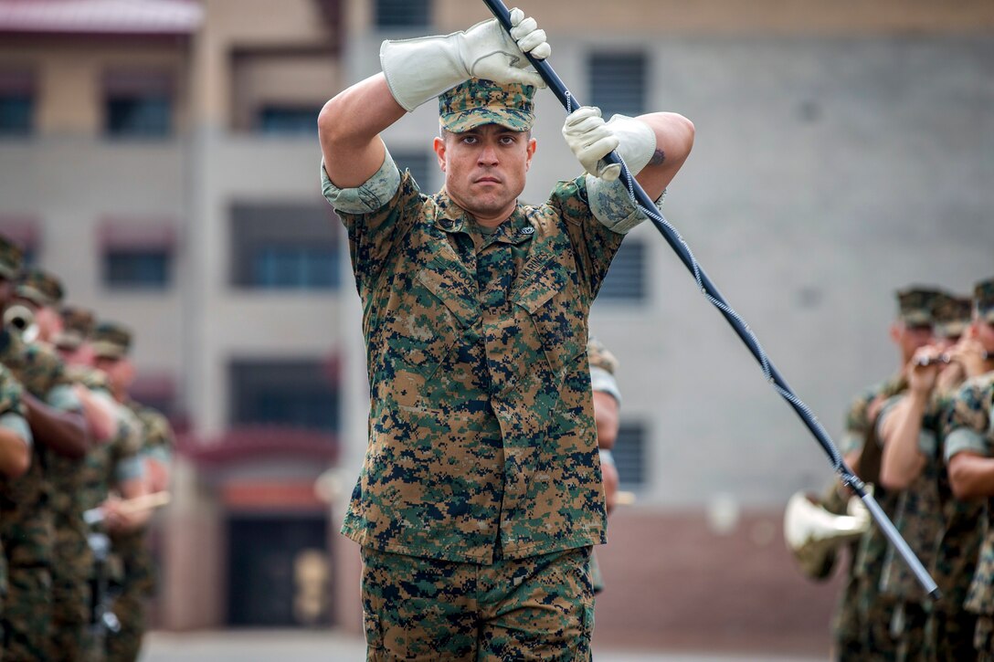 A Marine Corps drum major performs.