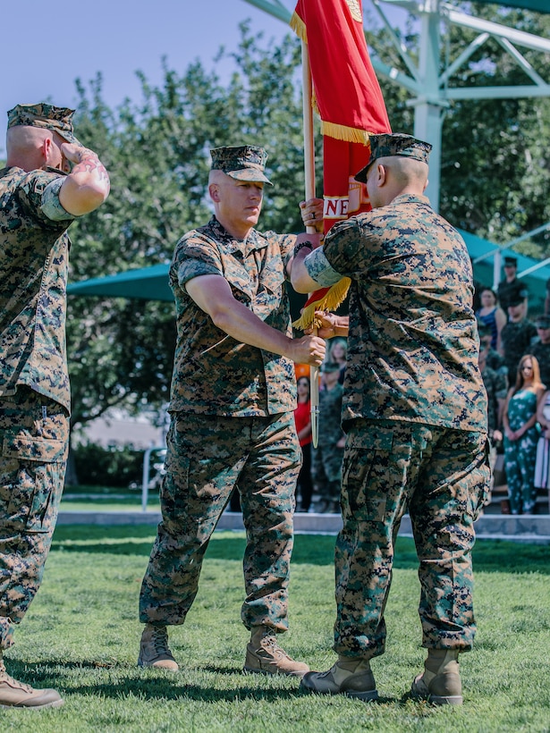 Lt. Col. Erick T. Clark, off-going commanding officer, 1st Battalion, 7th Marine Regiment, passes the battalion colors to Lt. Col. Robert M. Barnhart Jr., on-coming commanding officer, 1/7, during the unit’s change of command ceremony aboard the Marine Corps Air Ground Combat Center, Twentynine Palms, Calif., June 4, 2018. The exchange of colors, from an outgoing commander to an incoming one, is the crowning moment of the ceremony and ensures that the unit and its Marines are never without official leadership and also promotes a continuation of trust. (U.S. Marine Corps photo by Lance Cpl. Rachel K. Porter)