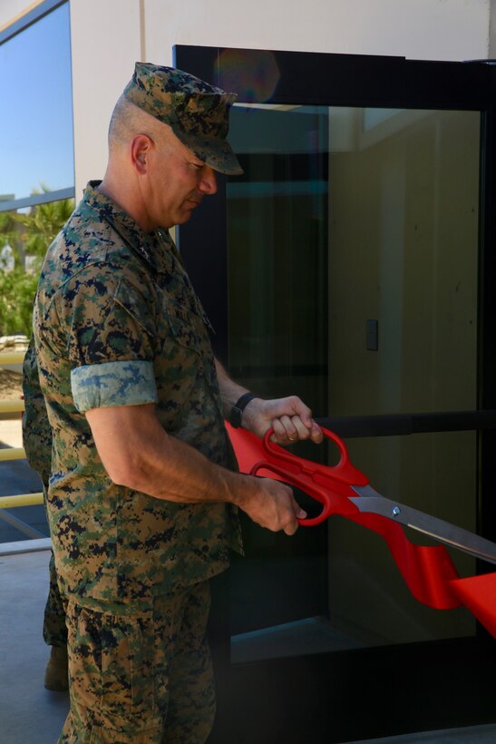 Combat Center Commanding General, Maj. Gen. William F. Mullen III, cuts the ribbon for the grand opening of the Wilburn Gym aboard the Marine Corps Air Ground Combat Center, Twentynine Palms, Calif., June 6, 2018. The gym was dedicated to retired Sgt. Maj. Ray V. Wilburn, a three-war veteran who left his mark on the installation and the local community. (U.S. Marine Corps photo by Lance Cpl. Dave Flores)